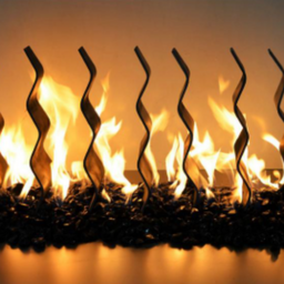Artificial fireplace insert with wavy metal flames on a dark background