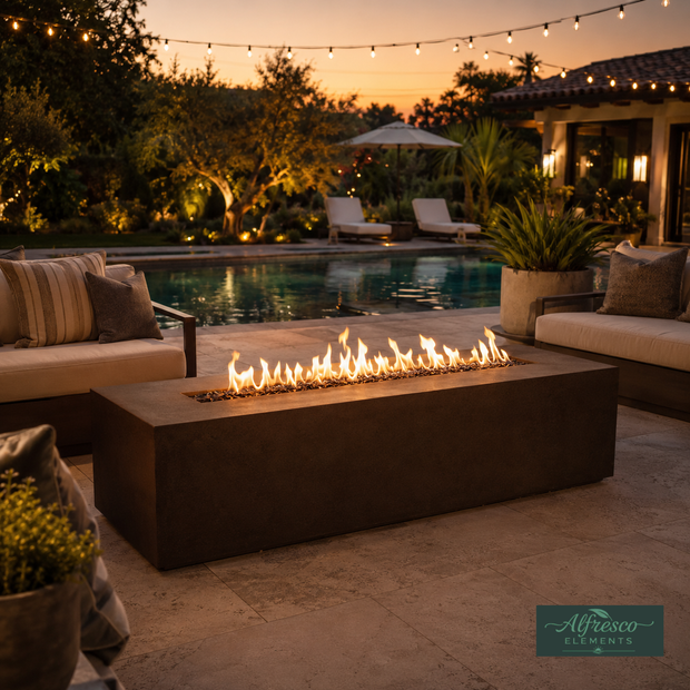 Outdoor patio with fire pit, pool, and lounge chairs at sunset.