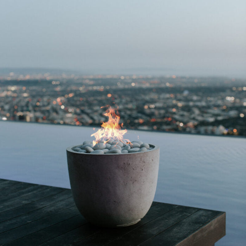 Fire pit with a cityscape view at dusk