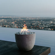 Fire pit with a cityscape view at dusk