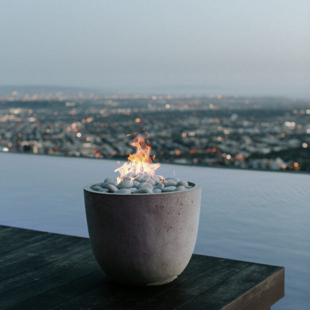Fire pit with a cityscape view at dusk