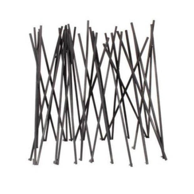 Black metal firewood holder with interwoven design on a white background