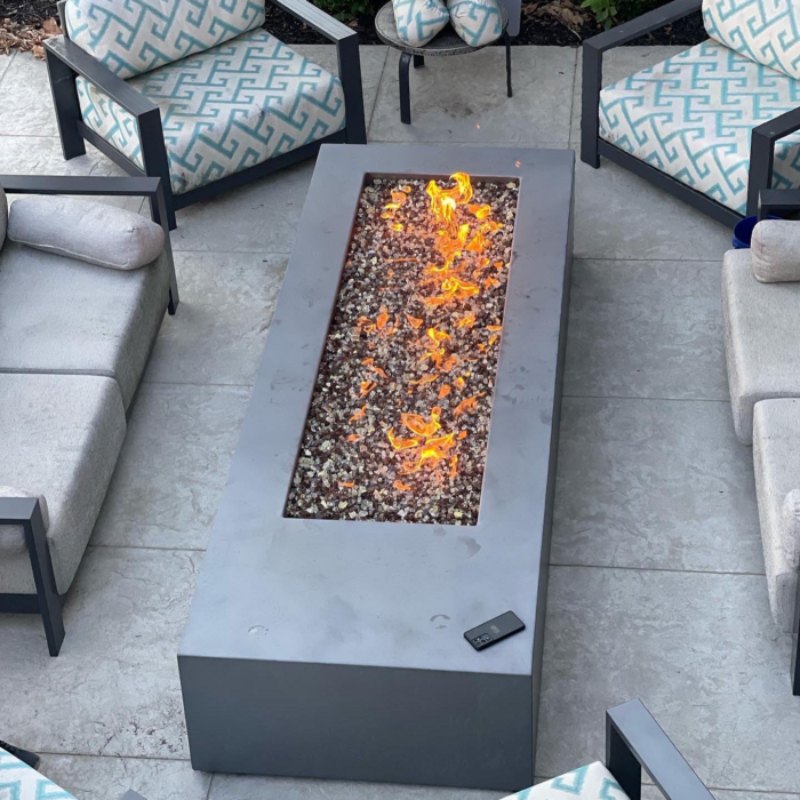 Outdoor patio with a fire pit table and seating area.