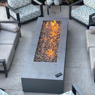 Outdoor patio with a fire pit table and seating area.