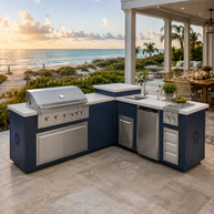 Outdoor kitchen with grill and sink overlooking a beach at sunset