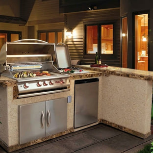 Outdoor kitchen with grill and island in a residential setting