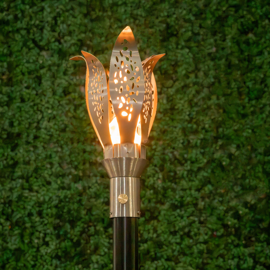 Floral-inspired 304 Stainless Steel torch head with 68-inch mounting post by The Outdoor Plus in garden setting