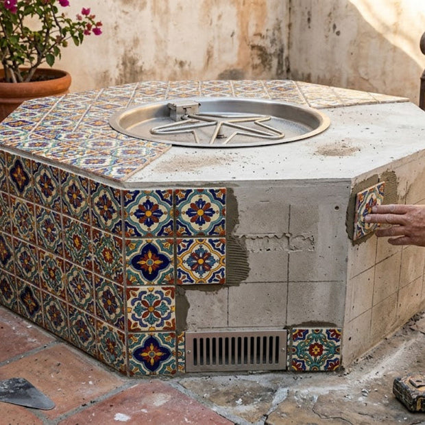 Hexagonal outdoor fire pit with decorative tiles being installed.