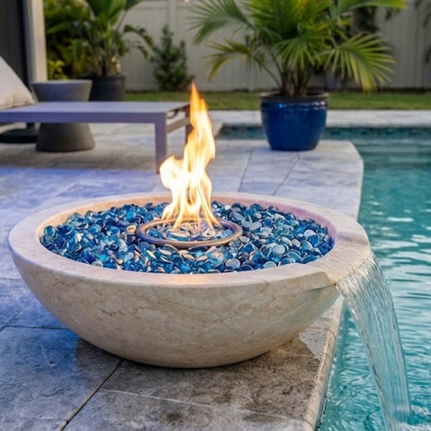 Fire pit with blue glass stones by a poolside