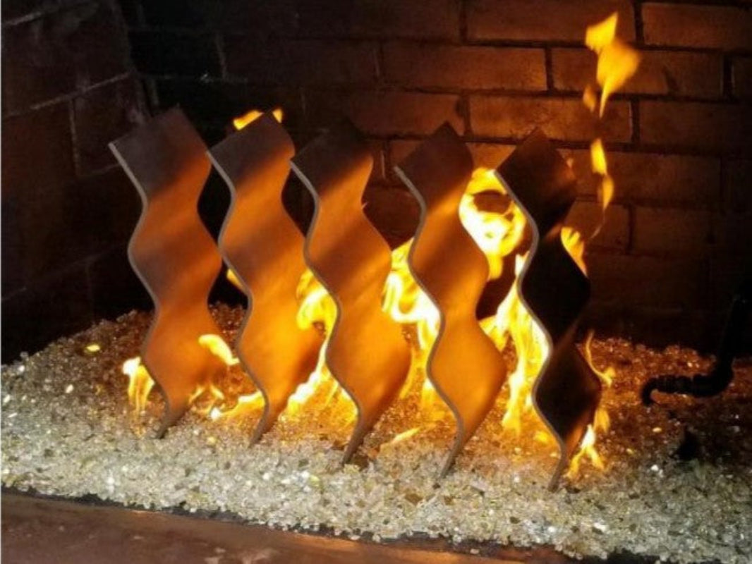 Decorative fireplace logs with flames against a brick background