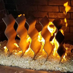 Decorative fireplace logs with flames against a brick background