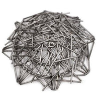 Pile of metal nails on a white background