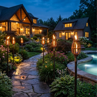 Evening view of a house with garden lights and a pool.